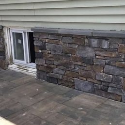 Stone Patio & Sliding Door — Stone patio with sliding glass door access.