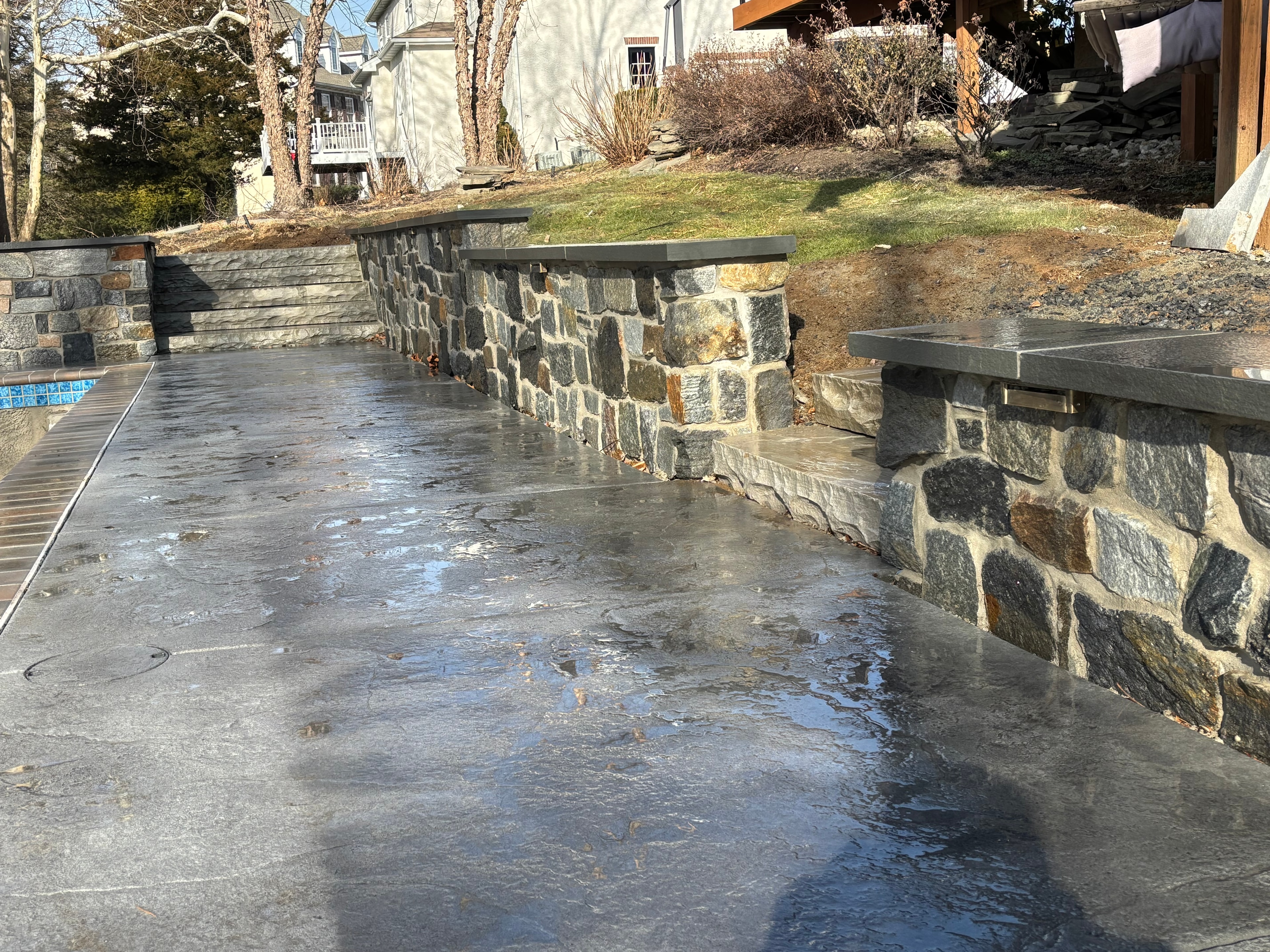 Pool Deck & Stone Walls — Bluestone pool deck with natural stone retaining walls.