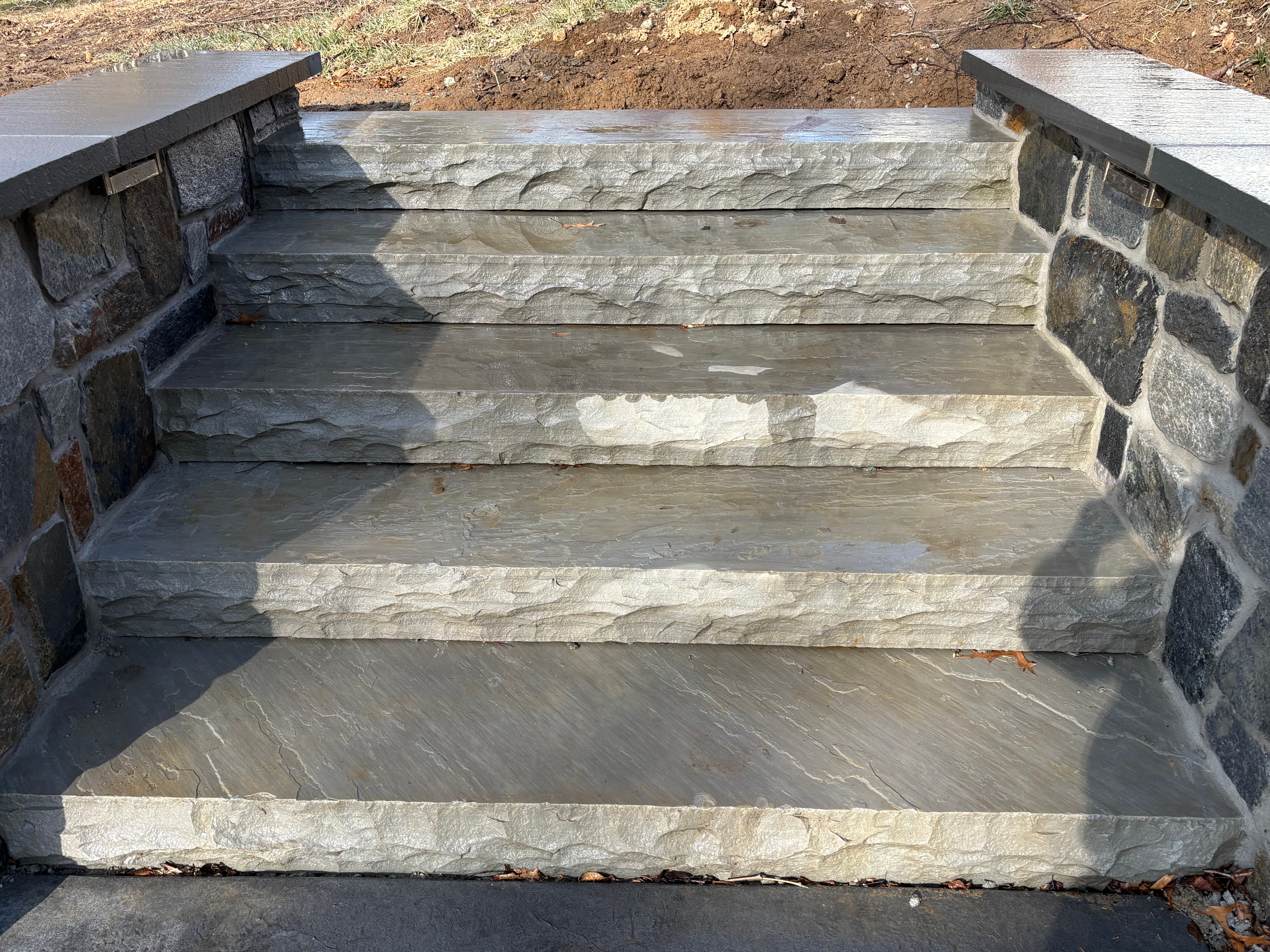 Natural Stone Steps — Elegant natural stone steps with stone wall flanking.