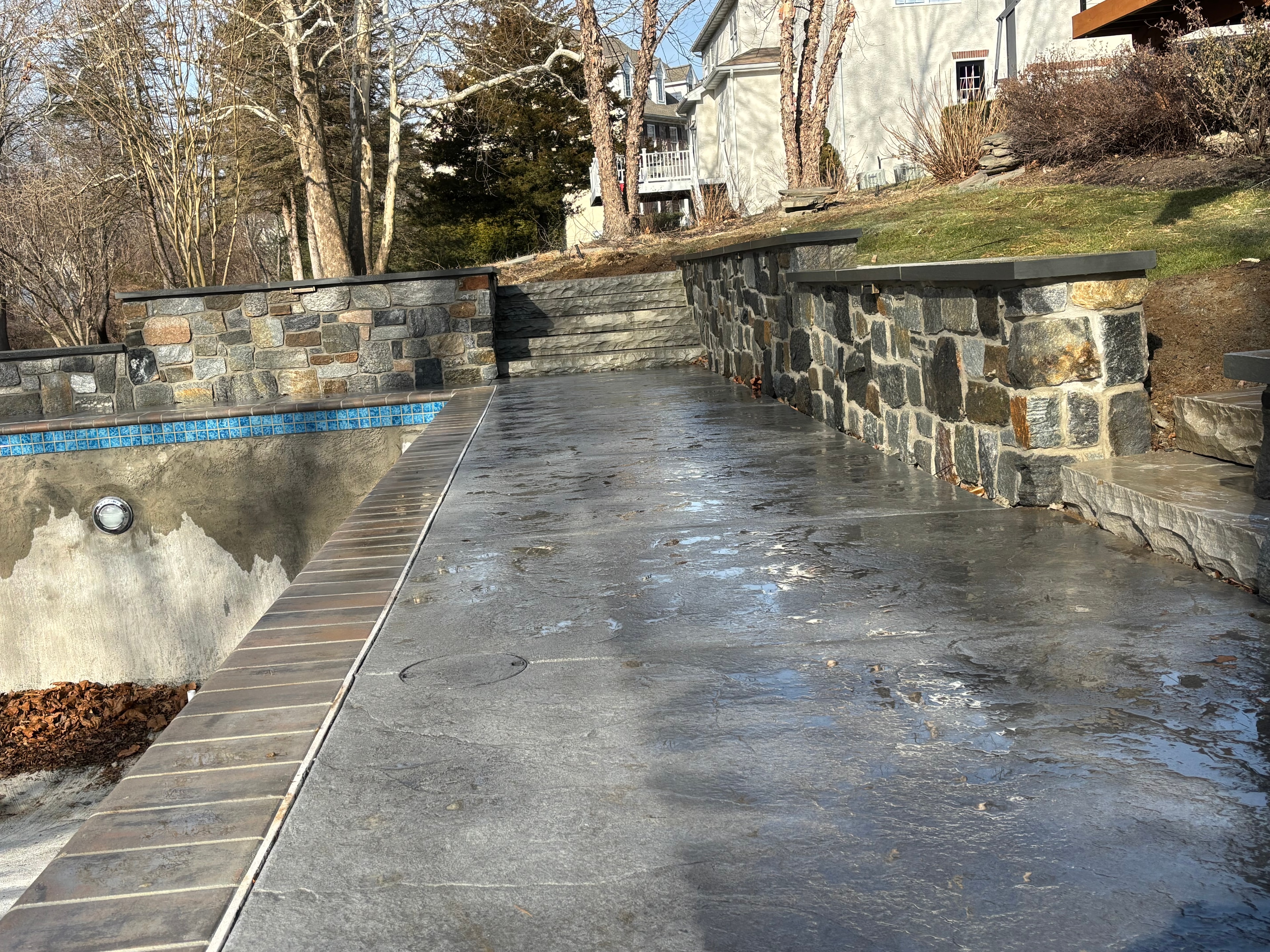 Pool Surround & Stone Walls — Full pool surround with bluestone deck and stone retaining walls.