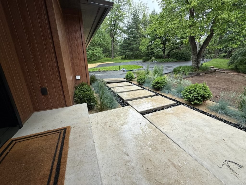 Stepping Stone Walkway — Modern stepping stone walkway with black river rock accents.