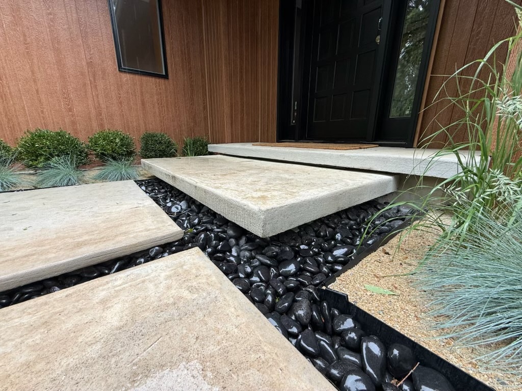 Modern Stone Entry Steps — Contemporary stone entry steps with black pebble landscaping.